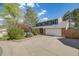 Attractive two-story house features manicured lawn, brick accents, a brick chimney and a two car attached garage at 9926 W Nova Pl, Littleton, CO 80127