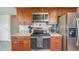 Spacious kitchen with stainless steel appliances, granite countertops, and wooden cabinets at 9926 W Nova Pl, Littleton, CO 80127