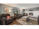 Relaxing living room with a cozy fireplace and view from the window at 9926 W Nova Pl, Littleton, CO 80127