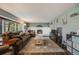 Spacious living room featuring a fireplace, large window, and an open layout at 9926 W Nova Pl, Littleton, CO 80127