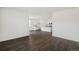 Spacious dining room with dark hardwood floors and access to kitchen at 9892 Cathay St, Commerce City, CO 80022