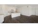 Modern kitchen with white cabinets, granite countertops, and island at 9892 Cathay St, Commerce City, CO 80022