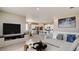 Open living room and kitchen with modern appliances and furniture at 9892 Cathay St, Commerce City, CO 80022