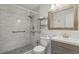 Upgraded bathroom features a tiled shower with sleek fixtures and built-in shelves at 5550 W 80Th Pl # 1, Arvada, CO 80003