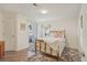 Cozy bedroom with a sliding glass door to the balcony and wood-look floors at 5550 W 80Th Pl # 1, Arvada, CO 80003