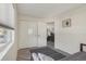 Bright bedroom boasts wood-look floors, a closet, and a view into the living room at 5550 W 80Th Pl # 1, Arvada, CO 80003