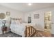 Bedroom boasts wood-look floors, a closet, and a view into the bathroom at 5550 W 80Th Pl # 1, Arvada, CO 80003
