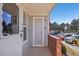 Condo entryway featuring a brick wall, and a view of parked cars and trees at 5550 W 80Th Pl # 1, Arvada, CO 80003