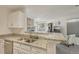 Bright kitchen overlooking the living area, features granite counters and stone fireplace at 5550 W 80Th Pl # 1, Arvada, CO 80003