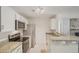 Bright kitchen features granite counters, stainless steel appliances, and white cabinetry at 5550 W 80Th Pl # 1, Arvada, CO 80003