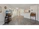 Open-concept living area featuring wood-look floors, easy access to the kitchen, and ample natural light at 5550 W 80Th Pl # 1, Arvada, CO 80003