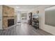 Open living space featuring a stone fireplace, new floors, and lots of natural light at 5550 W 80Th Pl # 1, Arvada, CO 80003