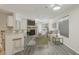 Bright living room with stone fireplace and TV, seamlessly connecting with the kitchen counter seating at 5550 W 80Th Pl # 1, Arvada, CO 80003