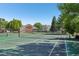 Community tennis courts surrounded by lush trees at 5550 W 80Th Pl # 1, Arvada, CO 80003