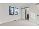 Bright bedroom with a sliding barn door leading to an en suite bathroom at 1928 W 41St Ave, Denver, CO 80211