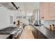Modern kitchen with a large island, professional-grade gas range, and open access to the living room at 1928 W 41St Ave, Denver, CO 80211