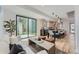 Bright and airy living room featuring hardwood floors and a seamless flow to the modern kitchen and backyard access at 1928 W 41St Ave, Denver, CO 80211