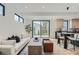 Bright living room with white walls, modern decor, and a view of the backyard through large sliding glass doors at 1928 W 41St Ave, Denver, CO 80211
