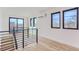 Modern staircase featuring black railings, hardwood floors and an abundance of natural light from several windows at 1928 W 41St Ave, Denver, CO 80211