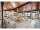 Bright living room featuring a vaulted ceiling, track lighting, and a sliding door to the porch at 10963 N Chatfield Dr, Littleton, CO 80125