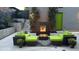 Cozy backyard with an outdoor seating around a modern fireplace and green accents at 3453 Navajo St, Denver, CO 80211