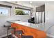Stylish bar area featuring stainless steel appliances, modern stools, and a bright window view at 3453 Navajo St, Denver, CO 80211