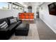 Finished basement with modern bar area, leather sectional couch, and convenient bathroom access at 3453 Navajo St, Denver, CO 80211