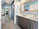 Modern bathroom with double vanity, soaking tub, and glass-enclosed shower; laundry visible at 3453 Navajo St, Denver, CO 80211