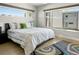 Bright bedroom with hardwood floors, a large window, and a cozy bed with green accent pillows at 3453 Navajo St, Denver, CO 80211