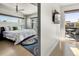 Bright bedroom with balcony access features a king bed, modern ceiling fan, and light-colored hardwood at 3453 Navajo St, Denver, CO 80211