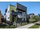 Modern home with unique architectural details, a fenced yard, and professional landscaping at 3453 Navajo St, Denver, CO 80211