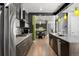 Gourmet kitchen with high-end appliances, a large island, and open access to the dining area at 3453 Navajo St, Denver, CO 80211