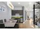 Modern kitchen with gray cabinets, stainless steel appliances and dining table with seating for four at 3453 Navajo St, Denver, CO 80211
