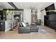 Open-concept living area with modern furnishings, fireplace, and seamless flow to the kitchen at 3453 Navajo St, Denver, CO 80211