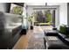Bright living room featuring a fireplace, leather sofa, and sliding doors to the backyard at 3453 Navajo St, Denver, CO 80211