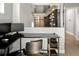 Modern office space with sleek black desk, ergonomic chair, and glass enclosed staircase in the background at 3453 Navajo St, Denver, CO 80211