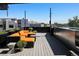 Rooftop deck featuring an outdoor seating area with an orange couch and views of the city at 3453 Navajo St, Denver, CO 80211