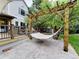 Backyard patio with hammock attached to a pergola offering a relaxing space at 10154 Fairgate Way, Highlands Ranch, CO 80126