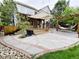 Landscaped backyard with custom patio, seating, hammock and lush greenery at 10154 Fairgate Way, Highlands Ranch, CO 80126
