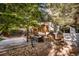 Expansive backyard featuring a deck, stone patio, hammock, and lush greenery at 10154 Fairgate Way, Highlands Ranch, CO 80126