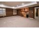 Finished basement with carpet, a built-in wet bar, cabinets, and space for entertaining at 10154 Fairgate Way, Highlands Ranch, CO 80126