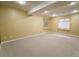 Neutral-colored basement with carpet, recessed lighting, and two large windows at 10154 Fairgate Way, Highlands Ranch, CO 80126