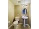 Half-bathroom with pedestal sink, toilet, and decorative mirror at 10154 Fairgate Way, Highlands Ranch, CO 80126