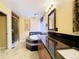 Beautiful bathroom with dual sinks, granite countertop, sleek cabinets, and tiled floors at 10154 Fairgate Way, Highlands Ranch, CO 80126