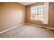 Bedroom featuring carpeted floors, neutral paint and a window with neighborhood views at 10154 Fairgate Way, Highlands Ranch, CO 80126