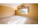 Bright bedroom featuring vaulted ceilings, a large window, and carpeted floors at 10154 Fairgate Way, Highlands Ranch, CO 80126