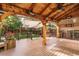A covered back deck with ceiling fan and ample seating with a view of the backyard at 10154 Fairgate Way, Highlands Ranch, CO 80126