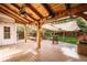 A covered back deck with ceiling fan and ample seating with a view of the backyard at 10154 Fairgate Way, Highlands Ranch, CO 80126