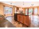 Kitchen with dark countertops, wooden cabinets, and modern appliances at 10154 Fairgate Way, Highlands Ranch, CO 80126