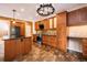 Modern kitchen with stainless steel appliances, wooden cabinets, and tiled floors at 10154 Fairgate Way, Highlands Ranch, CO 80126